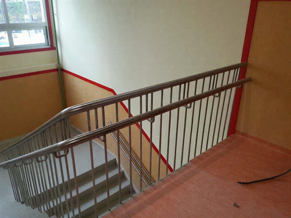 Pasamanos continuo de acero inoxidable en una escalera de Pontevedra